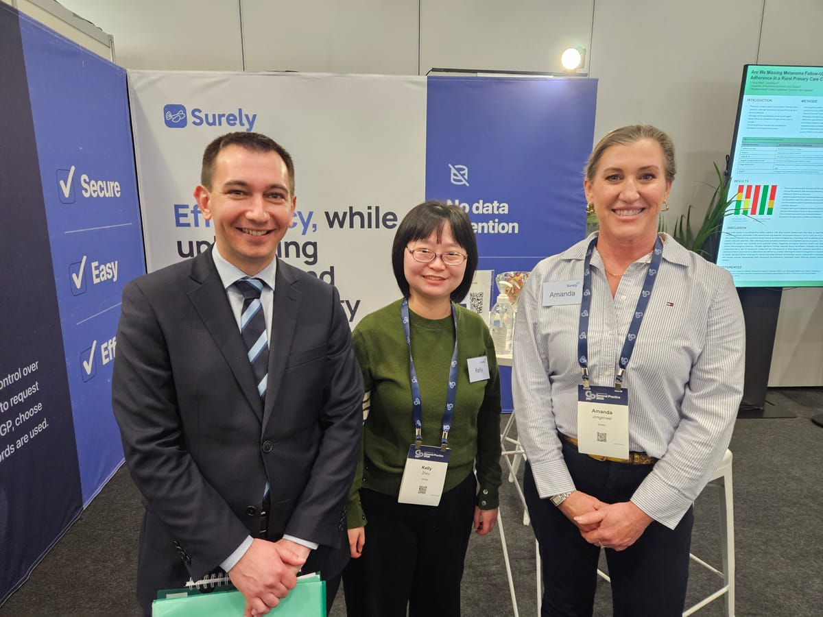 The Surely team with a guest at the Surely stand at GP26 in Auckland